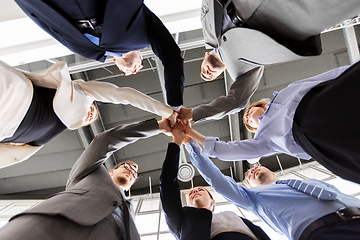 Image showing business people making high five at office