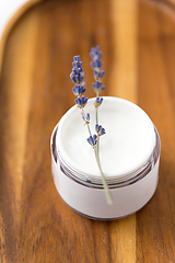 Image showing close up of lavender moisturizer on wooden tray