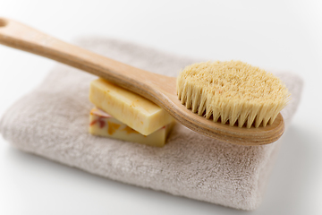 Image showing crafted soap bars, natural brush and bath towel