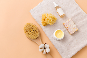 Image showing soap, brush, sponge and body butter on bath towel