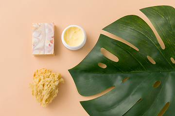 Image showing natural soap, sponge, body butter and monstera