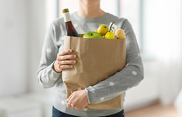 Image showing close up of woman with paper bag full of food