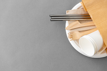 Image showing wooden forks, knives and paper cups on plate