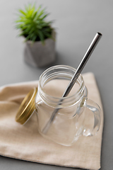 Image showing empty glass mug of with reusable metallic straw