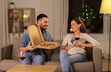 Image showing happy couple eating takeaway pizza at home