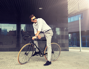 Image showing man with bicycle and headphones on city street