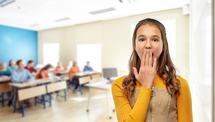 Image showing student girl closing her mouth by hand at school