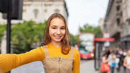 Image showing happy teenage girl taking selfie over london city