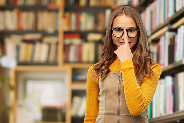 Image showing smiling teenage student girl in glasses at library