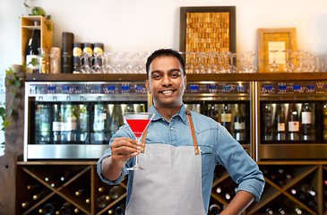 Image showing indian barman with glass of cocktail at bar