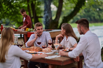 Image showing friends having picnic french dinner party outdoor during summer holiday