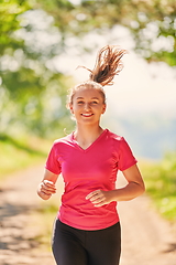 Image showing woman enjoying in a healthy lifestyle while jogging