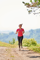 Image showing woman enjoying in a healthy lifestyle while jogging