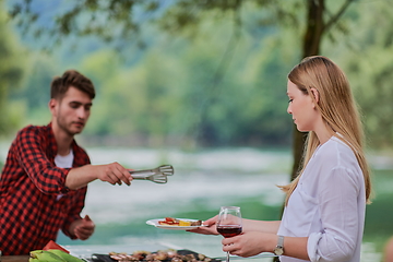 Image showing friends having picnic french dinner party outdoor during summer holiday