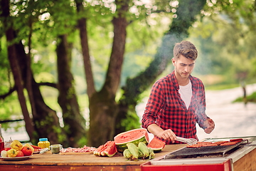 Image showing man cooking tasty food for french dinner party