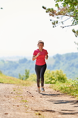 Image showing woman enjoying in a healthy lifestyle while jogging