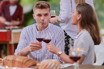 Image showing friends having picnic french dinner party outdoor during summer holiday