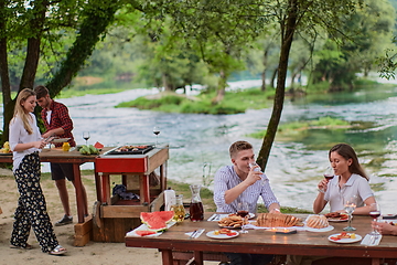 Image showing friends having picnic french dinner party outdoor during summer holiday