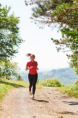 Image showing woman enjoying in a healthy lifestyle while jogging