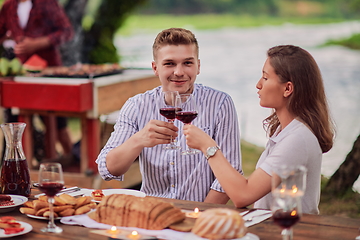 Image showing friends having picnic french dinner party outdoor during summer holiday