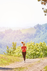 Image showing woman enjoying in a healthy lifestyle while jogging