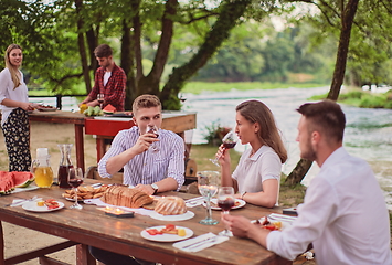 Image showing friends having picnic french dinner party outdoor during summer holiday