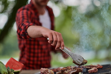 Image showing man cooking tasty food for french dinner party