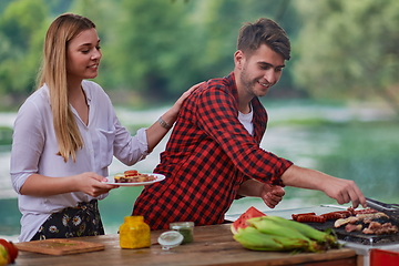 Image showing friends having picnic french dinner party outdoor during summer holiday