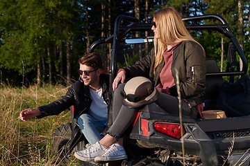 Image showing couple enjoying beautiful sunny day while driving a off road buggy