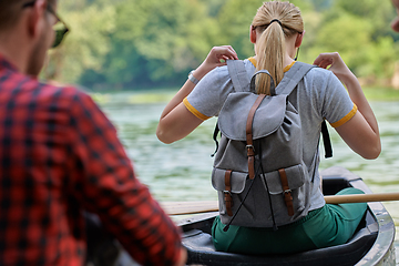 Image showing friends are canoeing in a wild river