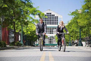 Image showing Business people riding bicycle