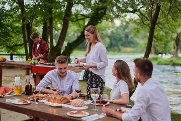 Image showing friends having picnic french dinner party outdoor during summer holiday