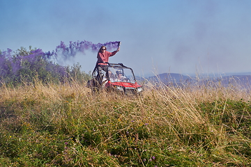 Image showing  colorful torches while driving a off road buggy car