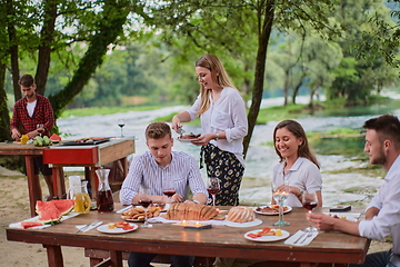 Image showing friends having picnic french dinner party outdoor during summer holiday