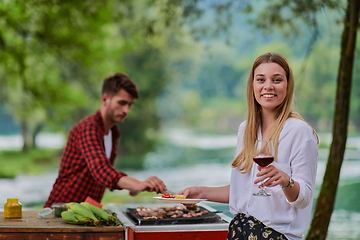 Image showing friends having picnic french dinner party outdoor during summer holiday