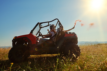 Image showing  colorful torches while driving a off road buggy car