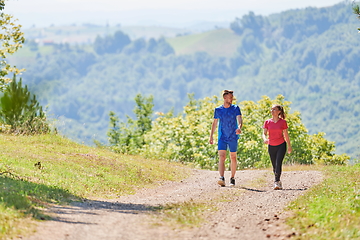 Image showing couple enjoying in a healthy lifestyle while jogging on a country road