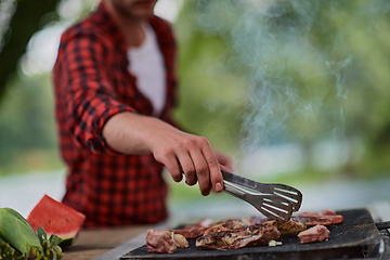 Image showing man cooking tasty food for french dinner party