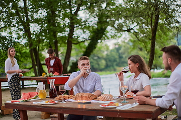 Image showing friends having picnic french dinner party outdoor during summer holiday