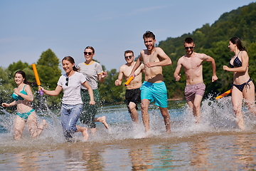 Image showing group of happy friends having fun on river