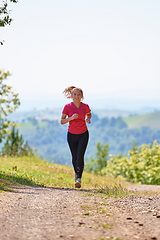 Image showing woman enjoying in a healthy lifestyle while jogging