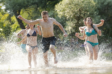 Image showing group of happy friends having fun on river