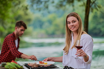 Image showing friends having picnic french dinner party outdoor during summer holiday