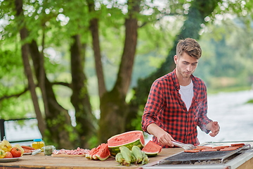 Image showing man cooking tasty food for french dinner party