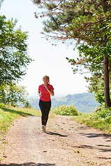 Image showing woman enjoying in a healthy lifestyle while jogging