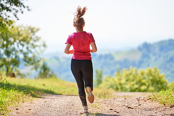 Image showing woman enjoying in a healthy lifestyle while jogging