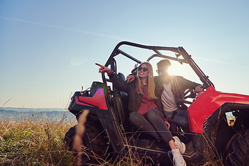 Image showing couple enjoying beautiful sunny day while driving a off road buggy