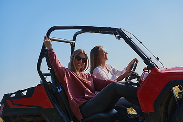 Image showing girls enjoying a beautiful sunny day while driving an off-road car