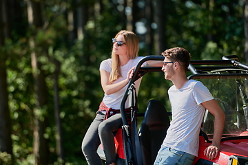 Image showing couple enjoying beautiful sunny day while driving a off road buggy