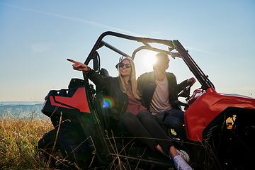 Image showing couple enjoying beautiful sunny day while driving a off road buggy